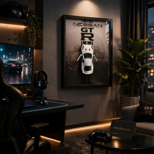 Luxury 3D Car Frame Wall Art With Mini Sports Car - Nissan GTR. Gaming setup with a monitor, chair, and framed Nissan GT-R poster in a dimly lit room.
