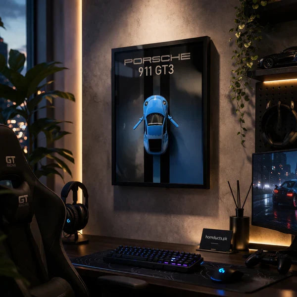 Luxury 3D Car Frame Wall Art With Mini Sports Car - Porsche. Gaming setup with Porsche 911 GT3 poster on a wall, desk with computer equipment, and cityscape view.