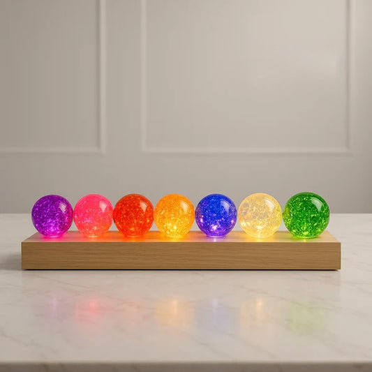 Crystal LED Globe Lamp – 7 Color Decorative Light On Wooden Base. Colorful crystal balls on a wooden base against a neutral background