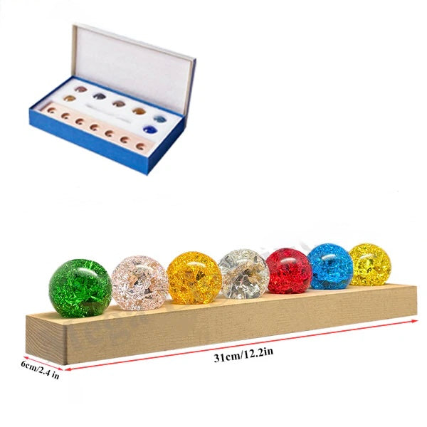 Crystal LED Globe Lamp – 7 Color Decorative Light On Wooden Base. Colorful crystal balls on a wooden stand with an open box containing additional items on a white background.
